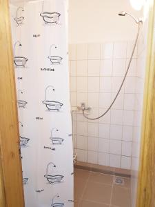 a bathroom with a shower with drawings of a bath tub at Sleep Inn Hostel in Bucharest