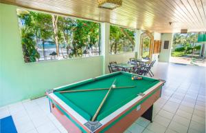 a pool table in the middle of a room at Back Door Village in Olivença