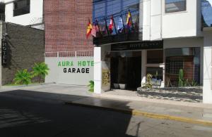 a hotel with flags on the front of a building at Aura Hotel in Chiclayo