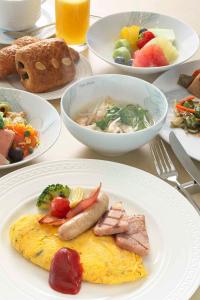 a table with plates of food and bowls of food at Osaka Marriott Miyako Hotel in Osaka