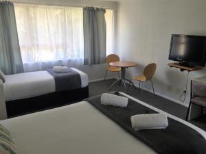 Llit o llits en una habitació de Fairway Motel & Apartments