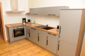 a kitchen with a sink and a stove at Apartments am Brunnen in Quedlinburg