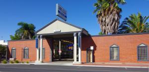 a red brick building with a garage at Jane Eliza Motor Inn in Swan Hill