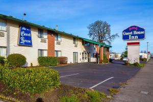 a guest house inn with a sign in front of it at Guest House Inn in Junction City