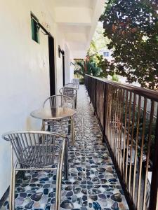 a patio with chairs and tables on a balcony at Ahras Place in Coron +33 photos