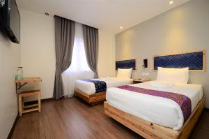 Postel nebo postele na pokoji v ubytování Artisan Eco Hotel