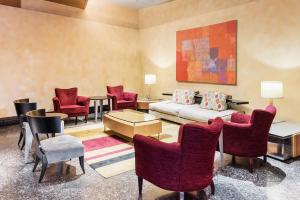 a living room with a couch and a table and chairs at Hotel Hanshin Osaka in Osaka +32 photos