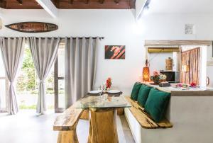 a living room with a bench and a table at Aura Villa & Spa Amed Bali in Amed