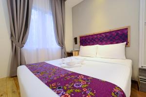 Postel nebo postele na pokoji v ubytování Artisan Eco Hotel