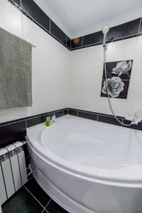 a white tub in a bathroom with a shower at Квартира in Temirtaū +28 photos