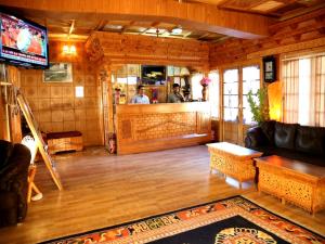 a living room with a couch and a bar at Hotel Royal Palace - Leh in Leh