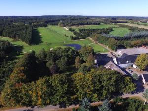 an aerial view of a golf course with trees and a lake at Tollundgaard Golf Park & Apartments in Funder Kirkeby