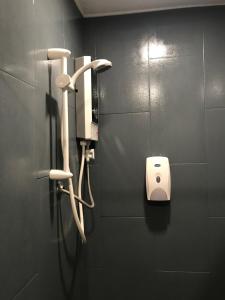 a public bathroom with a phone on a wall at Lima.Tujoh in Kuching