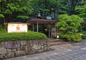 budynek z kamienną ścianą przed nim w obiekcie Kinugawa Park Hotels w mieście Nikko