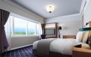 Letto o letti in una camera di Kawana Hotel