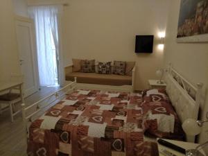 a bedroom with a bed and a couch at La Maison di Nicoletta in Gaeta