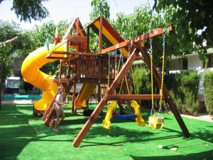 a playground with a slide in a park at Camping & Bungalows Oasis in Oropesa del Mar