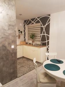 a kitchen with a table and a dining room at Apartament Nowe Maniowy in Maniowy +27 photos