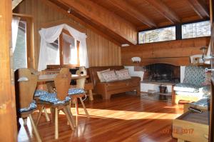 a living room with a table and a fireplace at I mughi - Cortina in Cortina dʼAmpezzo