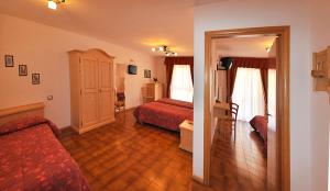 Postel nebo postele na pokoji v ubytování Hotel Piancastello