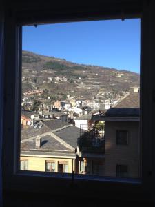 a view of a city from a window at Un nido nel centro storico con garage in Aosta