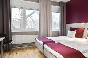 a hotel room with a bed and a window at Sure Hotel by Best Western Stockholm Alvsjo in Stockholm