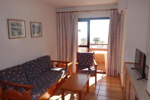 a living room with a couch and a table at Apartamentos Estrella De Mar in Roquetas de Mar