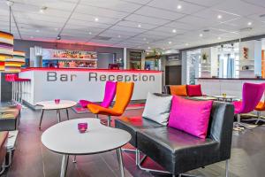 a bar reception with colorful chairs and tables at Sure Hotel by Best Western Stockholm Alvsjo in Stockholm