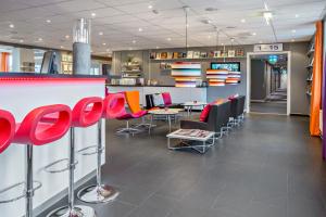 a restaurant with chairs and tables in a room at Sure Hotel by Best Western Stockholm Alvsjo in Stockholm