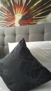 a black pillow sitting on top of a bed at Hotel Werratal in Bad Sooden-Allendorf