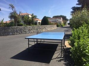 a blue ping pong table in the middle of a street at Camping Barataud in Saint-Denis-dʼOléron