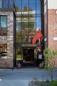 a building with a flag in front of it at Daugirdas Old City Hotel in Kaunas