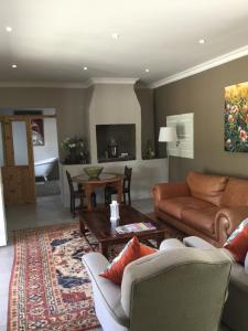 a living room with a couch and a table at Broadlands Country House in Kirkwood