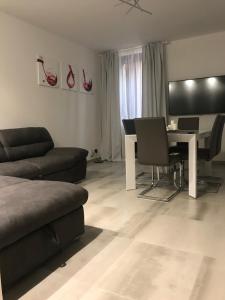 a living room with a couch and a table with chairs at Loft Sirmione in Sirmione