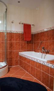 a bathroom with a bath tub and a sink at Weena House in Rotterdam
