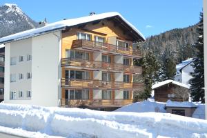 a large building with snow in front of it at Ferienwohnung Bündawiese in Davos