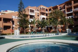 a swimming pool in front of a apartment complex at Apartamentos Estrella De Mar in Roquetas de Mar