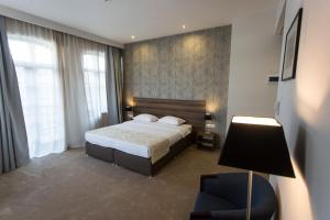 Postel nebo postele na pokoji v ubytování Old Meidan Tbilisi By Urban Hotels