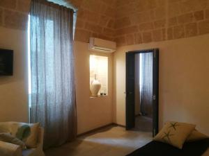 a living room with a door and a window at Casa Carlotta in Monopoli