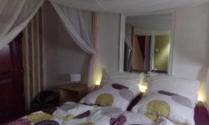 a bedroom with a bed with two pillows and a window at Privatzimmer Neu-Isenburg in Neu Isenburg