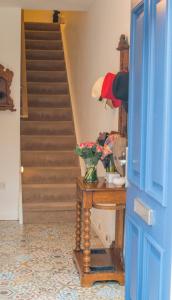 um corredor com uma porta azul e uma mesa com flores em 2 Mikes Homestay em Dublin