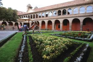 a horse is standing in front of a building at Monasterio, A Belmond Hotel, Cusco in Cusco