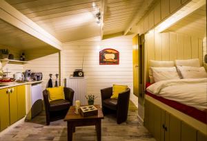 a small room with a bed and two chairs and a table at Bed en Breakfast Gees in Gees