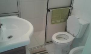 a bathroom with a white toilet and a sink at Leohome in Melo