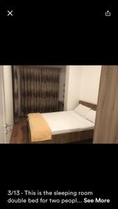 a small bedroom with a bed with at 1 Bedroom flat in Kosovo Polje