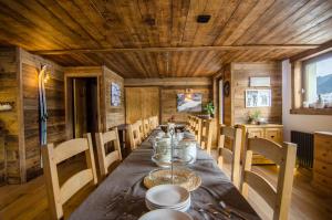 a dining room with a long table and chairs at Chalet Sandy in Les Gets