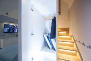 a bedroom with a bed and a staircase with a mirror at Casa Amore S Lucia in Amalfi
