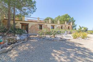 a stone house with a balcony on top of it at Pura Vida in Jávea