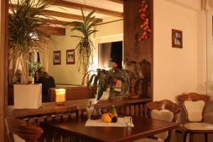 a dining room with a table and a mirror at Gasthof-Pension Hunaustuben in Schmallenberg