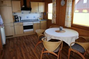 a kitchen with a table and chairs and a kitchen with a table and chairsktop at Ferienhaus 2 Köhr-Eickhoff in Lembruch